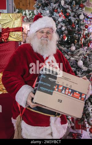Weihnachtsmann mit Weihnachtsgeschenken, die bei Amazon bestellt wurden. Mailand Italien - Dezember 2022 Stockfoto