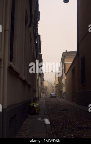 Enge Kopfsteinpflasterstraße an einem nebligen Tag Stockfoto