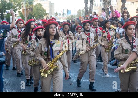 Haifa, Israel - 17. Dezember 2022 : Schüler der St. Elias Bischofsschule nimmt an der Weihnachtsparade in der deutschen Kolonie Teil. Die Zuschauer beobachten sie Stockfoto