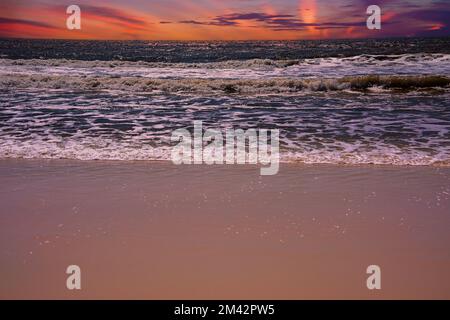 Der magentafarbene Abendhimmel über dem Golf von Mexiko in Destin Beach, Florida Stockfoto