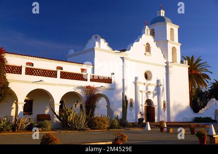 Die Mission San Luis Rey de Francia, eines von mehreren spanischen Kirchen und katholischen Zentren, leuchtet hell im kalifornischen Sonnenlicht in Oceanside Stockfoto