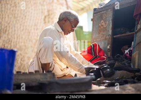 Ein Schuster, der auf den Straßen von Delhi Schuhe repariert Stockfoto