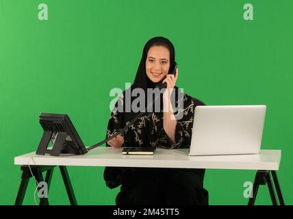 Eine Araberin, die im Büro telefoniert. Stockfoto