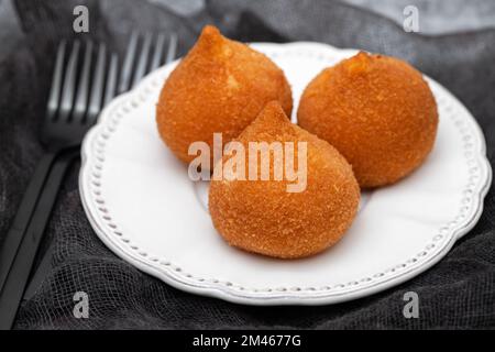 Traditionelle brasilianische gebratene Unterschenkel Coxinha de Frango auf einem kleinen weißen Gericht Stockfoto