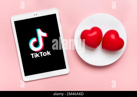 Bangkok, Thailand Dezember 2022 Smartphone Tik Tok Anwendungssymbol, Logo auf dem Bildschirm, wie zwei rote Herzen auf rosa Hintergrund trendiges Social-Media-Netwo Stockfoto