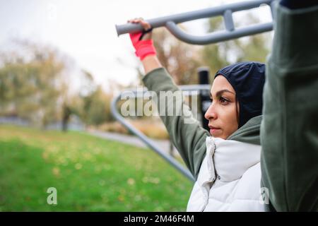 Junge muslimische Frau im Sport-Hijab, die auf dem Outdoor-Trainingsgelände trainiert. Stockfoto