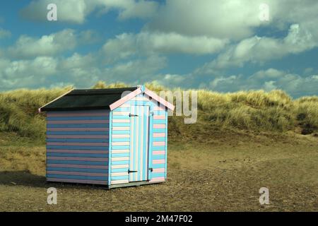 Einzelne Strandhütte an einem Sandstrand mit Sanddünen. Stockfoto