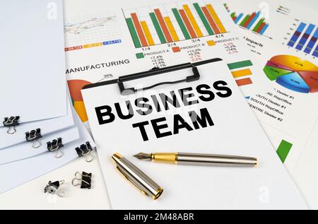 Geschäftskonzept. Auf der Tabelle unter Finanzdiagrammen und -Diagrammen befindet sich ein Tablet mit der Aufschrift „Business Team“ Stockfoto
