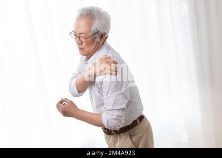 Ein ranghöchster Chinese leidet an Schulterschmerzen Stockfoto
