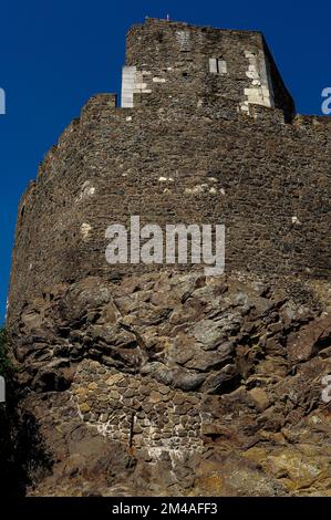 Schlachtnarben: Die alten Trümmermauern der nordungarischen Burg Hollókő, die von Jahrhunderten der Belagerungskriegsführung zerschmettert wurden, sind heute auch offensichtliche Anzeichen für Reparaturen und Flickungen in den letzten Jahrzehnten. Die Festung, die in den späten 1200s Jahren im Cserhát-Hochland erbaut wurde, wurde von örtlichen Kriegsherren, osmanischen Türken, Hussiten und Befreier unter der Führung des Königs von Polen gehalten. Stockfoto