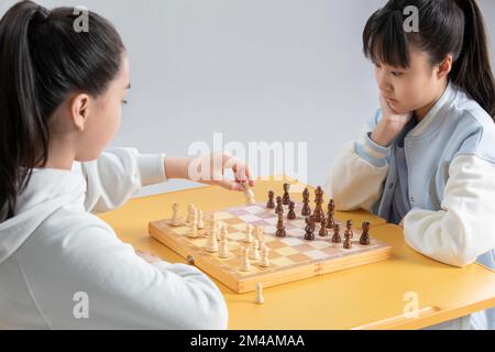 Zwei chinesische Mädchen spielen Schach Stockfoto