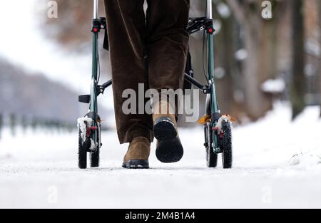 München, Deutschland. 20.. Dezember 2022. Ein Mann läuft mit seinem Roller auf einem eisigen Bürgersteig am Nymphenburger Kanal. Kredit: Sven Hoppe/dpa/Alamy Live News Stockfoto