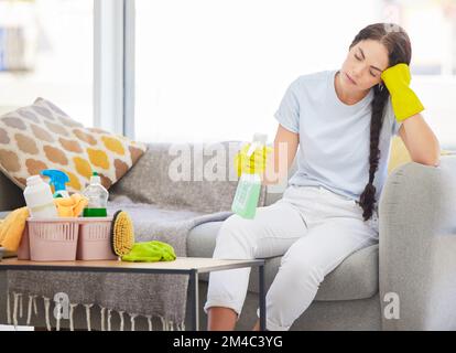 Müde, traurige und Frühjahrsputzfrau im Wohnzimmer mit Burnout, Stress und Ermüdung durch Housekeeping, Wartung und Routineaufgaben. Erschöpft Stockfoto