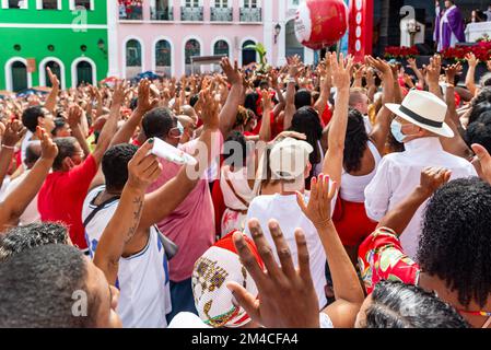 Die gläubigen Katholiken von Santa Barbara erheben ihre Waffen zum Himmel zu Ehren des Weihnachtsmanns. Pelourinho, Salvador, Bahia Stockfoto