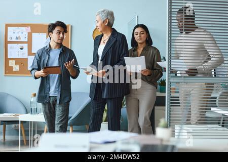 Multiethnische Gruppe von Geschäftsleuten mit weiblicher Chefin während des Arbeitsprozesses im Büro Stockfoto