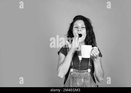 Gähnende Frau riechen heißes Getränk. Genießen Sie leckeres Getränk. Mädchen trinken Kaffee Form Tasse. Frisch und lecker. Holen Sie sich etwas Energie am Morgen. Morgen Stockfoto