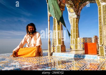 Sadhu kümmert sich um einen Tempel auf der Oberseite des Girnar Hill Stockfoto