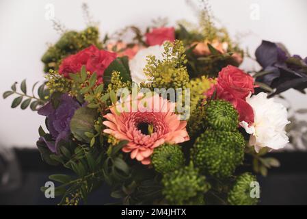 Wunderschöne Blumenarrangements aus der Nähe, ein Strauß gemischter Blumen aus Nelken in Gerberas in einem Blumenladen Stockfoto