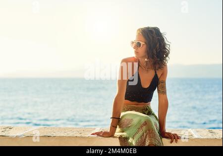 Genießen Sie die spektakuläre Aussicht. Eine wunderschöne junge Frau draußen. Stockfoto