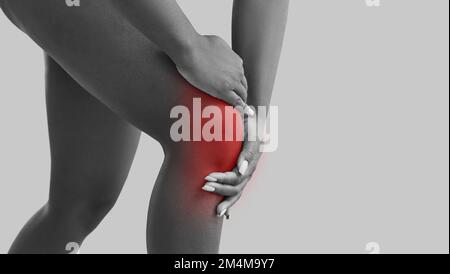 Eine Frau, die an Arthritis leidet, fühlt Schmerzen und berührt ihr Knie, Bannerhintergrund Stockfoto