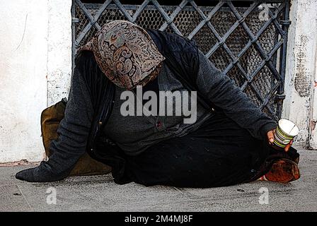 Ein Obdachloser, der bettelt, sitzt auf den Straßen von Venedig, Italien Stockfoto