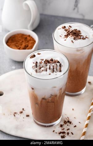 Kalte heiße Schokolade in großen Gläsern mit Milchschaum Stockfoto
