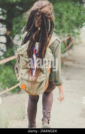 Eine Frau mit Dreadlock, die Treppen hinuntergeht, malerische Fotografie Stockfoto