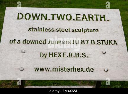 Unterschreiben Sie über die Down Two Earth, Skulptur aus Edelstahl von einer heruntergekommenen Junkers JU87 Stuka auf dem RAF Battle of Britain Memorial, Capel-le-Ferne, England Stockfoto