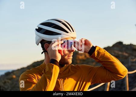 Radfahrer mit Helm und Schutzbrille, die an sonnigen Tagen stehen Stockfoto