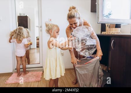 Mutter und Tochter sammeln Plastikmüll in der Küche Stockfoto