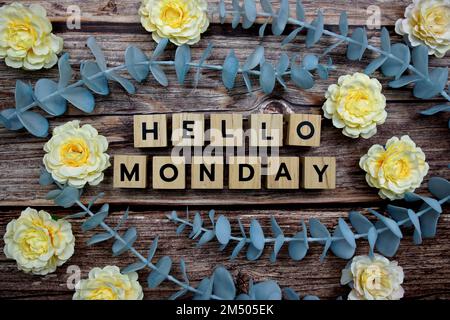 Hallo Montag Alphabet Buchstaben und Blume schmücken auf Holzhintergrund Stockfoto