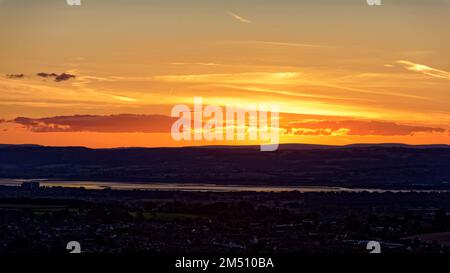 Blick auf den Sonnenuntergang über dem Fluss Severn von Cam Long Down, Dursley, Gloucestershire, Großbritannien Stockfoto