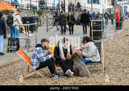 Lyme Regis, Dorset, Großbritannien. 24. Dezember 2022 Wetter in Großbritannien. Besucher an der Küste des Lyme Regis in Dorset genießen einen warmen, bedeckten Tag am Heiligabend. Bildnachweis: Graham Hunt/Alamy Live News Stockfoto