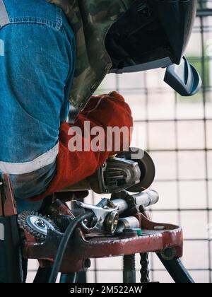 Ein Mann, der in einer Werkstatt am Löten von Lötkolben arbeitet Stockfoto