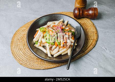 Gungjungtteokbokki, koreanischer königlicher Reiskuchen im Stir-Fried : langer zylinderförmiger Tteok (Garaetteok), in Stücke geschnitten und mit Rindfleisch gebraten, Shitak Stockfoto