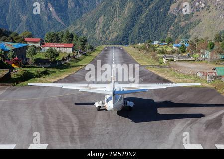 LUKLA/NEPAL - 18. OKTOBER 2015: Kleines Flugzeug, das sich für den Start vom Flughafen Tenzing-Hillary in Lukla nach Kathmandu bereit macht. Stockfoto