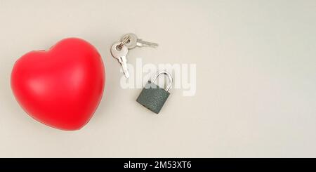 Menschen- und Symbolkonzept. Auf der grauen Oberfläche befinden sich Herz, Schloss und Tasten. Banner mit Platzierung für Text. Stockfoto