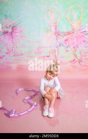 Süße kleine Ballerina, die im Studio Übungen macht Stockfoto