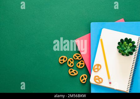 Notizbücher auf grünem Hintergrund, Schulkonzept, flach liegend. Stockfoto