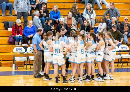 Das Basketballteam der Mädchen der Lakewood Park Christian High School versammelt sich während einer Auszeit bei Bethany Christian HS in Goshen, Indiana, um den Coach. Stockfoto