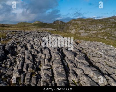 Unvergleichliche Aussicht auf Kalksteinpflaster in der Nähe von Malham mit Comb Hill und Dean Moor Hill in der Ferne Stockfoto