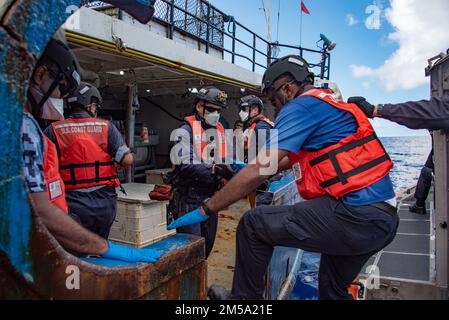 USA Mitglieder der Küstenwache, die der USCGC Stratton (WMSL 752) zugewiesen sind, und Partner von Fidschi, gehen während illegaler, nicht gemeldeter und unregulierter Fischereieinsätze in Fidschi an Bord eines Fischereifahrzeugs, 13. Februar 2022. Die Besatzung von Stratton sorgt für die Aufrechterhaltung der Sicherheit, während sie auf den Pazifikinseln Strafverfolgungsbehörden einrichtet. Stockfoto