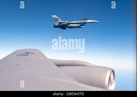 EIN US-AMERIKANISCHER Air Force F-16 Fighting Falcon, dem 18. Aggressor-Geschwader zugeteilt, fliegt zusammen mit einem 909. Air-Tanken-Geschwader KC-135 Stratotanker über dem Pazifik zur Unterstützung von COPE North 22, 16. Februar 2022. Übungen wie Cope North ermöglichen es den Pacific Air Forces, neue Wege für den Einsatz und das Manövrieren von Ressourcen zu validieren. Stockfoto