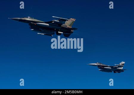 USA Air Force F-16 Kampfflugzeuge, die dem 18. Aggressor-Geschwader zugeteilt sind, betanken mit einem KC-135 Stratotanker-Flugzeug, das der 909. Luftbetankungsschwadron zugeteilt wurde, während der Übung COPE North 22 über dem Pazifik, 17. Februar 2022. CN 22 ermöglicht es jeder Nation, ihre Fähigkeiten in Bezug auf die Bereitschaft zu verbessern und die Interoperabilität zwischen mehreren Einsatzbereichen zu verbessern. Dazu gehören Luftüberlegenheit, Sperrung, elektronische Kriegsführung, taktische Lufttransporte und Luftbetankungsmöglichkeiten. Stockfoto