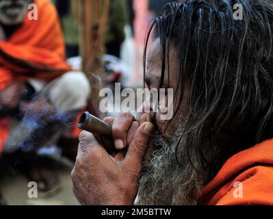 Ein Shaivite Sadhu raucht Chillum auf dem Mallick Ghat am Hooghly River in Kalkutta, Indien. Stockfoto