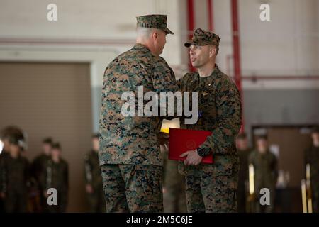 USA Marinekorps Maj. Corey Jones, ein KC-130J Super Hercules Pilot mit Fleet Replacement Detachment (rechts), schüttelt sich mit Major General Michael Cederholm, Commanding General of 2. Marine Aircraft Wing, bei einer Preisverleihung in der Marine Corps Air Station Cherry Point, North Carolina, am 28. Februar 2022. Jones, ein Einheimischer aus Charlotte, North Carolina, wurde mit dem Distinguished Flying Cross für die Durchführung einer Notlandung ausgezeichnet, nachdem ein anderes Flugzeug mit seinem KC-130J Super Hercules kollidierte. Jones' Pilotenfähigkeiten und rechtzeitige Entscheidungen in den kritischsten Momenten der 12 Minuten aus der Luft Stockfoto