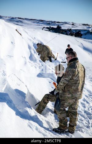 USA Air Force-Mitglieder der 123. Contingency Response Group, mit der Kentucky National Guard Practice, die Schneehöhlen für das Training bei extrem kaltem Wetter während des Trainings Arctic Eagle-Patriot 2022 in Nome, Alaska, 2. März 2022 baut. Die gemeinsame Übung Arctic Eagle-Patriot 2022 erhöht die Fähigkeit der Nationalgarde, in rauen, extrem kalten Witterungsbedingungen in Alaska und der Arktis zu operieren. AEP22 verbessert die Fähigkeit militärischer und ziviler interinstitutioneller Partner, auf eine Vielzahl von Notfall- und Heimatschutzmissionen in Alaska und der Arktis zu reagieren. Stockfoto