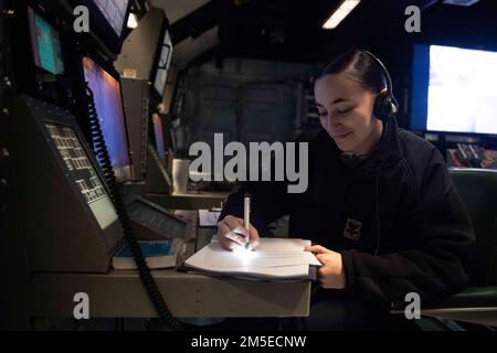 PACIFIC OCEAN (7. März 2022) Operations Specialist 2. Klasse Bethany Dixson aus Troy, Ohio, zugewiesen zum taktischen Luftkontrollgeschwader 12 an Bord des nach vorn eingesetzten Amphibienschiffs USS America (LHA 6), verfolgt die Bewegungen von Flugzeugen der America Amphibious Ready Group (ARG). Amerika, das führende Schiff der America ARG, ist zusammen mit der 31. Marine Expeditionary Unit im Zuständigkeitsbereich der US-amerikanischen 7.-Flotte tätig, um die Interoperabilität mit Verbündeten und Partnern zu verbessern und als einsatzbereite Eingreiftruppe zur Verteidigung von Frieden und Stabilität in der Region Indo-Pazifik zu dienen. Stockfoto