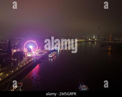 Düsseldorfer weihnachtsmarkt und Riesenrad in deutschland bei Nacht. Blick auf Skyline und rhein aus der Vogelperspektive. Nachts im Winter. Stockfoto