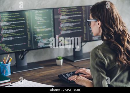 Profilporträt einer intelligenten, talentierten Hardware-Expertin Lady Keyboard, die Code in Innenräumen eingibt Stockfoto